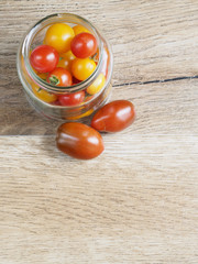 Cherry tomatoes background in a glass jar