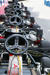go-kart car parked next to track side selective focust in steering wheel