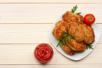 Homemade cutlets with tomato and broccoli on a wooden table. Healthy food. top view with copy space