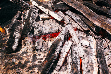 Wooden blocks with ash on fire