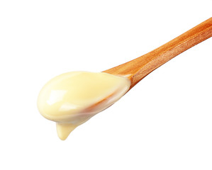 Condensed Milk in wooden spoon