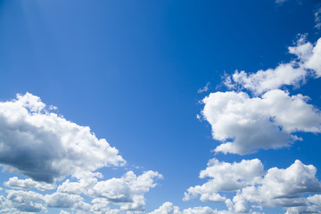Naklejka na ściany i meble Blue sky with clouds in sunny day. Background.