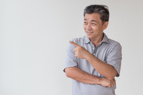 Old, Middle Aged, Senior Asian Man Looking And Pointing Finger Away Gesture