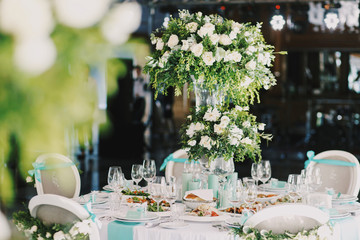 Rich bouquet of roses stands on the dinner table