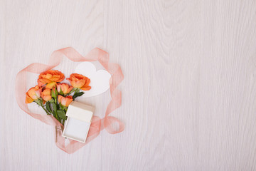 Creative mock up layout made of roses  with copy space on table homemade flat lay. Empty sheet of heart card. a blank piece of paper. ribbon