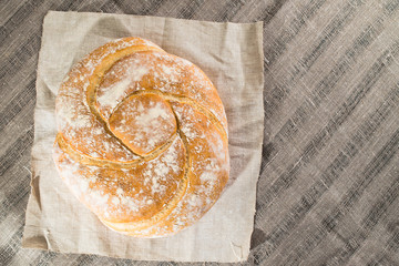 baked good on a light textile background, flat lay, capital bun