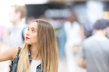 Beautiful teenager girl looking up, close up photo with defocused copy space background