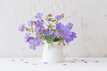 flowers in jug on white background