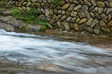 Stream Flowing Through Rocks in village.