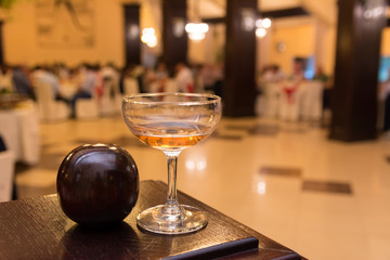 Champagne glass and a blurry background with a wedding hall