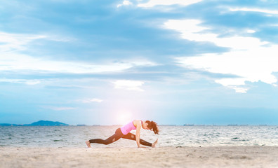 Young asian yoga exercise with posting on the beach in summer outdoor