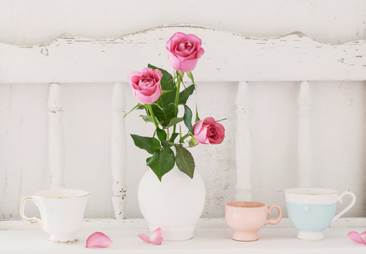 pink rose on white wooden shelf