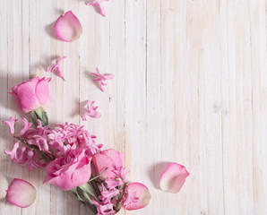 Flowers in a waffle cone on white wooden background