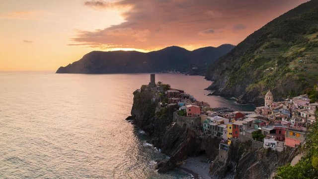 sunset and blue hour timelapse of travel landmark destination Vernazza, a small mediterranean sea town, Cinque terre National Park, Liguria, Italy. Clouds, flare, sunlight. 4k time lapse video shot