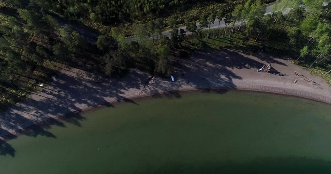 Finnish beach, Cinema 4k aerial tilt view away from olmos beach, on a sunny morning, in Kemionsaari, Uusimaa, Finland