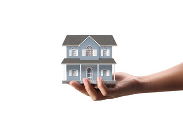 Mortgage concept by house from  hand