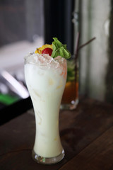 pina colada cocktail with pineapple and cherry fruit