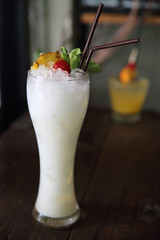 pina colada cocktail with pineapple and cherry fruit