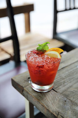 mai tai cocktail with orange cherry fruits on wood background