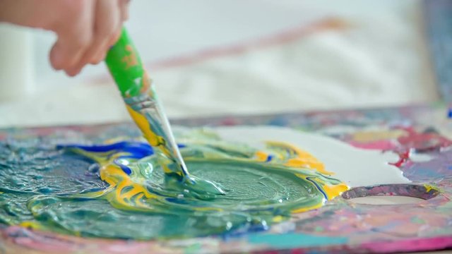 Kids are using tempera colours in their art class and they are making some beautiful paintings.