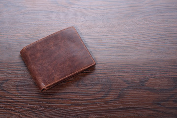 Brown man wallet on wooden background