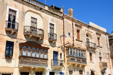 Fototapeta na wymiar Buildings with interesting balconies and windows, Vittoriosa, Malta.