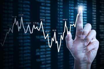 businessman with financial chart symbols coming from hand