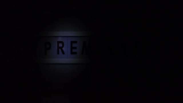 Vintage illuminated lightbox Premiere sign in cinema movie or for radio and television live audience broadcast