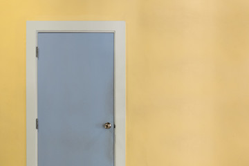 Empty entry pastel blue door and light yellow wall, pastel tone, background