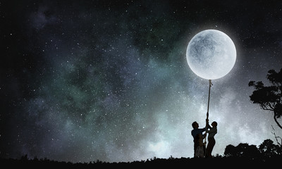 Fototapeta na wymiar People catching moon