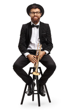 Trumpet player sitting on a chair