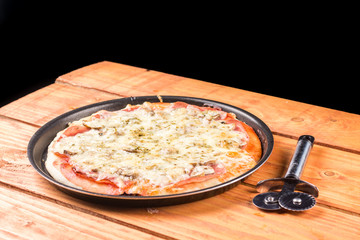 Flat lay above baked pizza on the wooden boards table