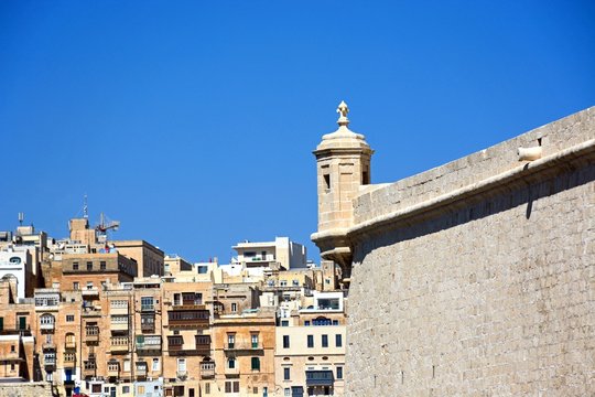 Corner tower on Fort Saint Angelo with views towards Valletta, Vittoriosa.