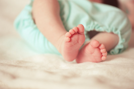 Baby feet closeup. Selective focus.