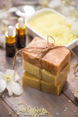 Obraz na płótnie Canvas Handmade Soap and Aroma Oil with Flower branch. Spa products.