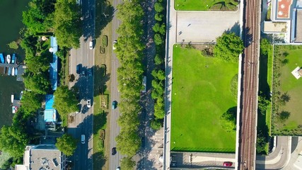 Obraz premium Aerial top down view of car road, boat berth and railroad on a sunny summer day. Different means of transport