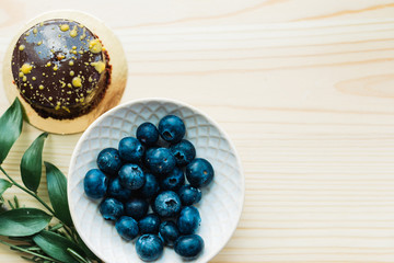 cake and berries on a wooden background