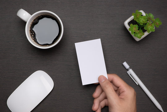 Business card blank over coffee cup and pen at office table.