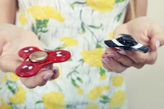 girl holds two spinners
