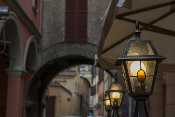 Fototapeta na wymiar Small street italian lanterns near the old arch
