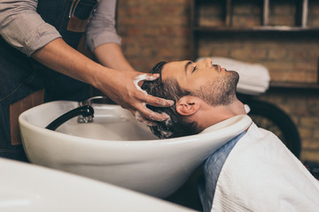 hairstylist washing clients hair