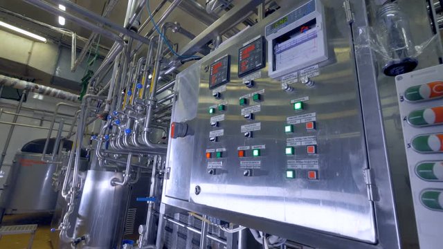 A dairy factory control panel with green activated and red inactivated buttons. 4K.