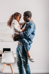 african american man holding daughter