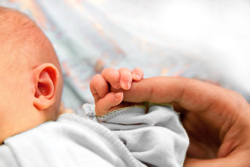 The baby clung to the pope's finger