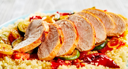 Poultry cut in slices served with couscous