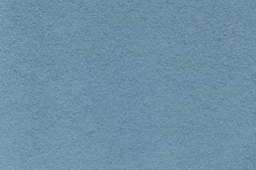 Texture of old blue paper closeup. Structure of a dense cardboard. The azure background.