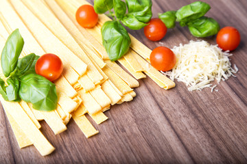 Italian raw Pasta Fettuccine on the wood background