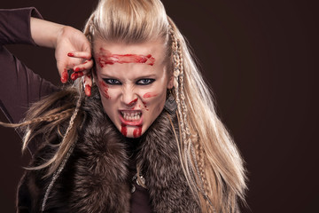 Portrait of viking woman in a traditional warrior clothes.