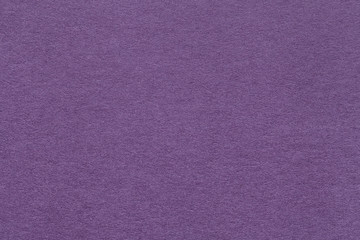 Texture of old dark violet paper closeup. Structure of a dense cardboard. The lavender background.