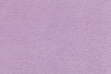 Texture of old light violet paper closeup. Structure of a dense cardboard. The lavender background.